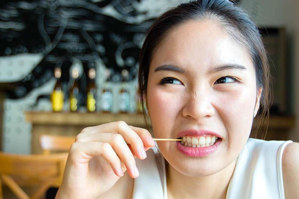 Woman using a toothpick 1